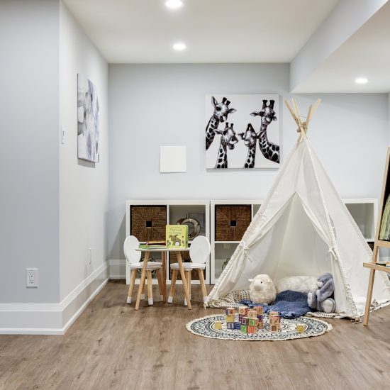 child's playroom with bedsheet tent and art easel